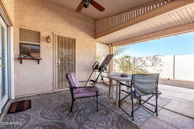 view of patio with ceiling fan and a mountain view