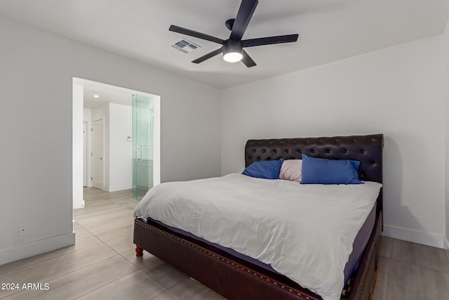 bedroom featuring ceiling fan and ensuite bath