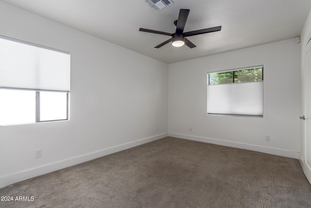 carpeted spare room with ceiling fan