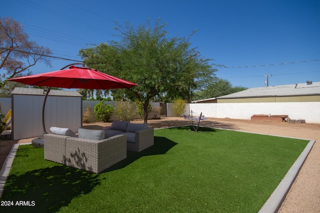 view of yard with outdoor lounge area, a shed, and a patio area