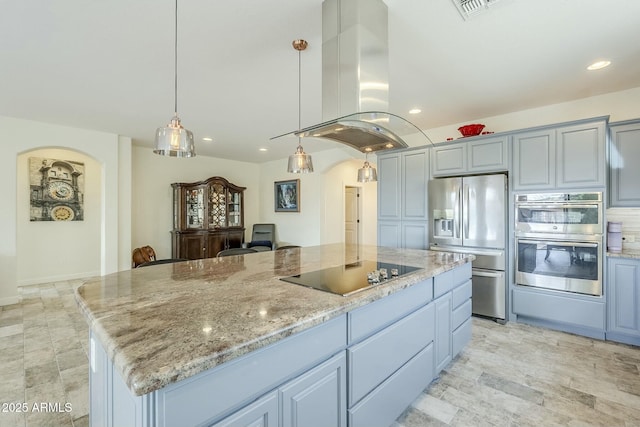 kitchen with stainless steel appliances, light stone countertops, a center island, and island range hood