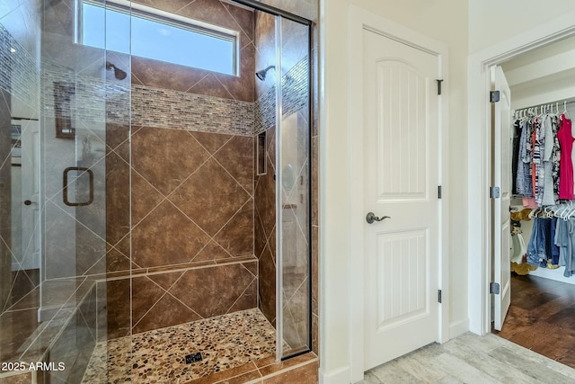 bathroom with wood-type flooring and walk in shower