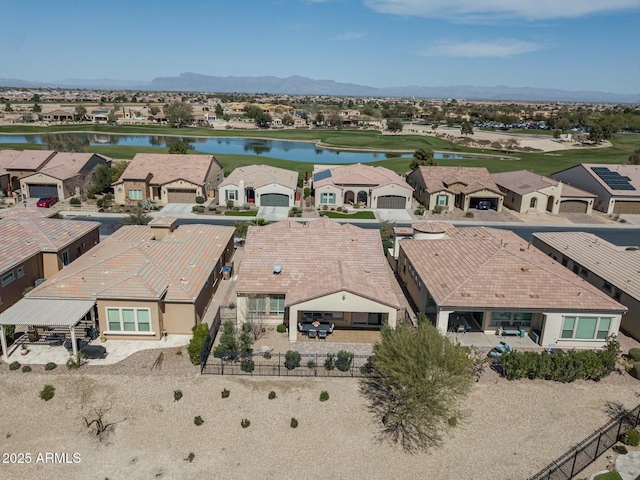 birds eye view of property with a water and mountain view