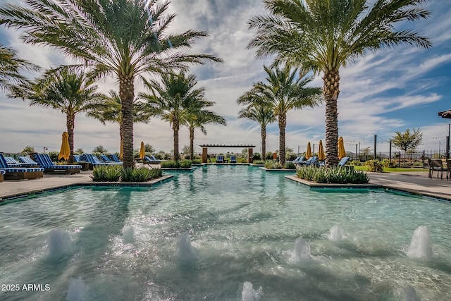 view of pool featuring pool water feature, a pergola, and a patio area