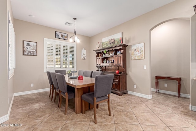 dining space with an inviting chandelier and light tile patterned floors