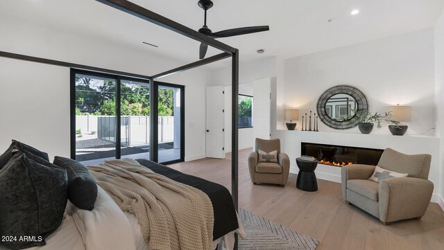 bedroom with light hardwood / wood-style flooring and access to outside