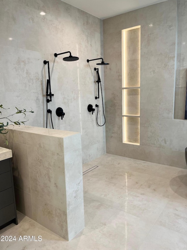 bathroom with vanity and tiled shower