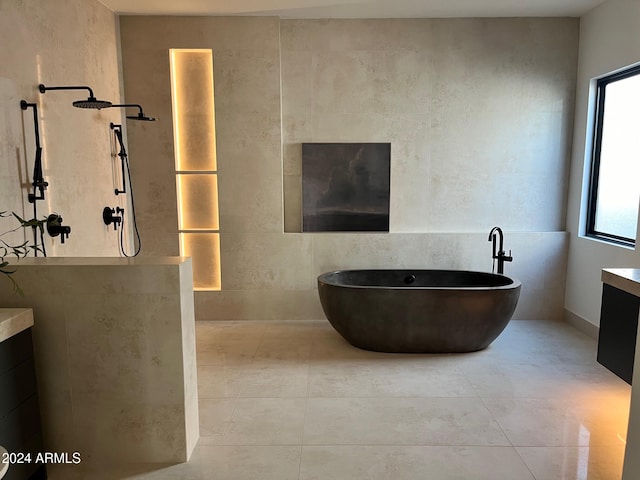 bathroom featuring vanity, plenty of natural light, and plus walk in shower