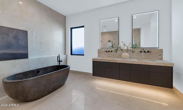 bathroom featuring a tub to relax in, tile patterned flooring, and vanity