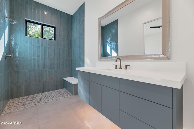 bathroom featuring vanity, tiled shower, and tile patterned floors