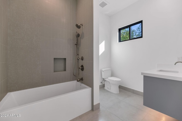 full bathroom featuring tile patterned floors, toilet, tiled shower / bath combo, and vanity