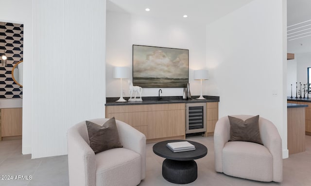 sitting room featuring beverage cooler and wet bar