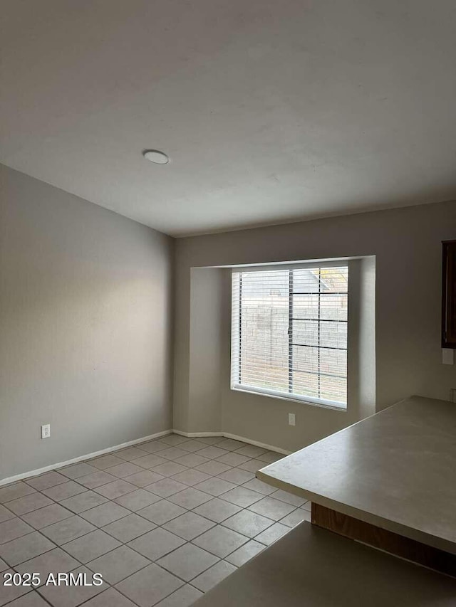 spare room featuring light tile patterned floors