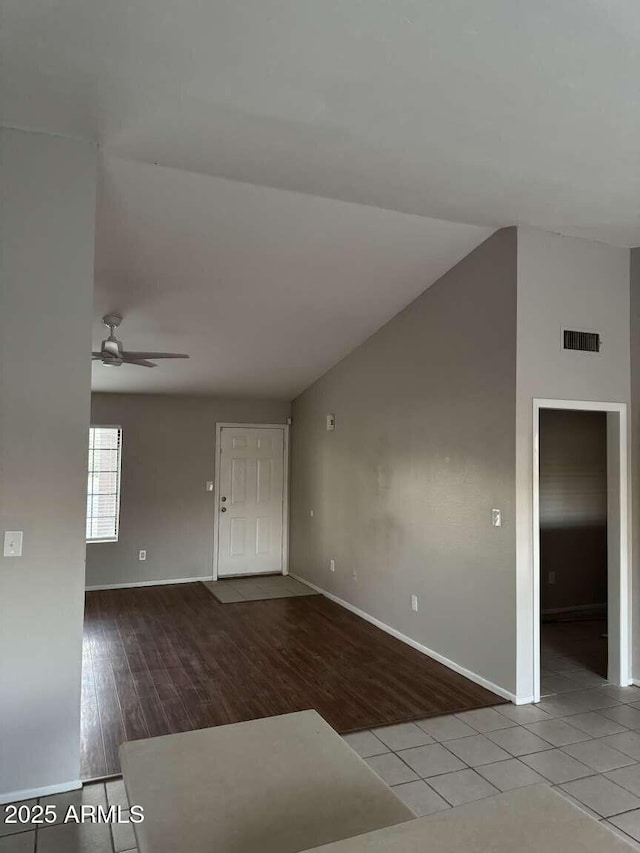 spare room featuring vaulted ceiling, ceiling fan, and light hardwood / wood-style flooring