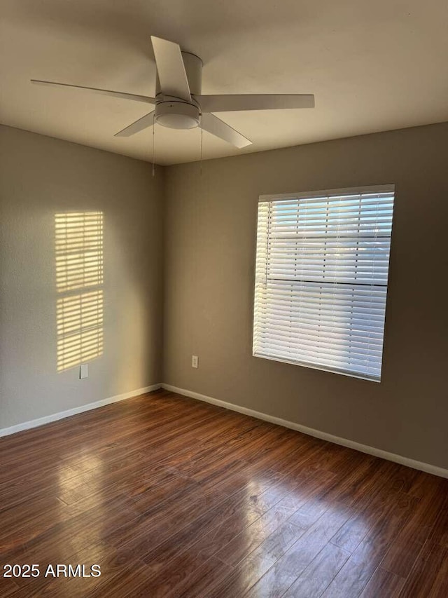 unfurnished room with ceiling fan and dark hardwood / wood-style floors