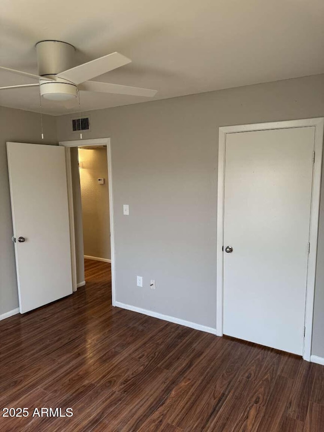 unfurnished bedroom with dark wood-type flooring and ceiling fan