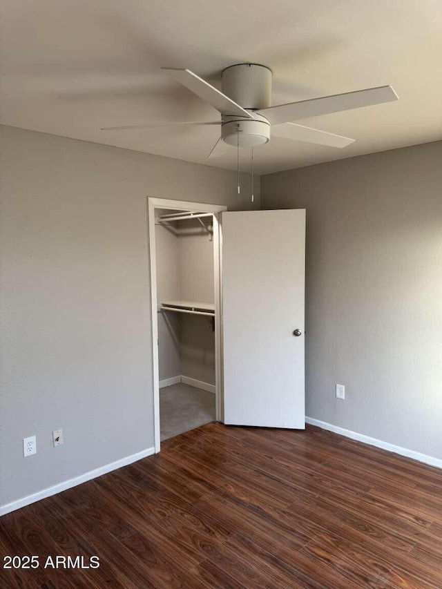 unfurnished bedroom featuring dark hardwood / wood-style flooring, a closet, and ceiling fan