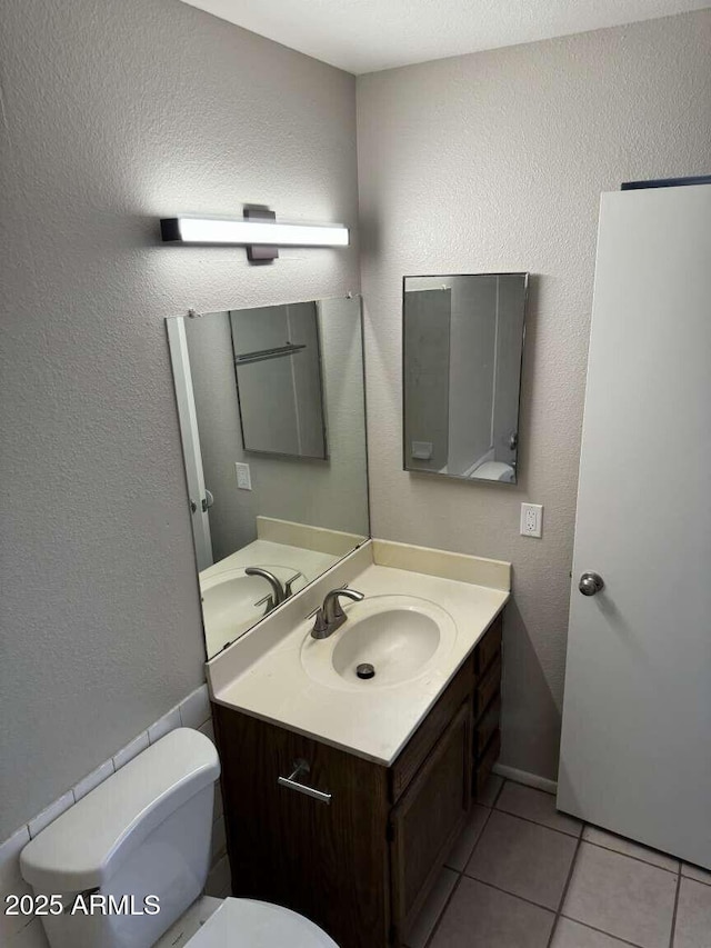 bathroom featuring tile patterned floors, vanity, and toilet