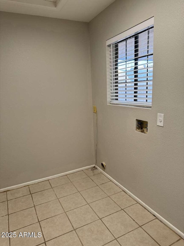 washroom featuring washer hookup and light tile patterned flooring