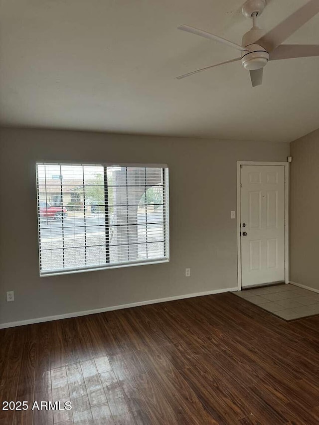 empty room featuring ceiling fan and dark hardwood / wood-style flooring