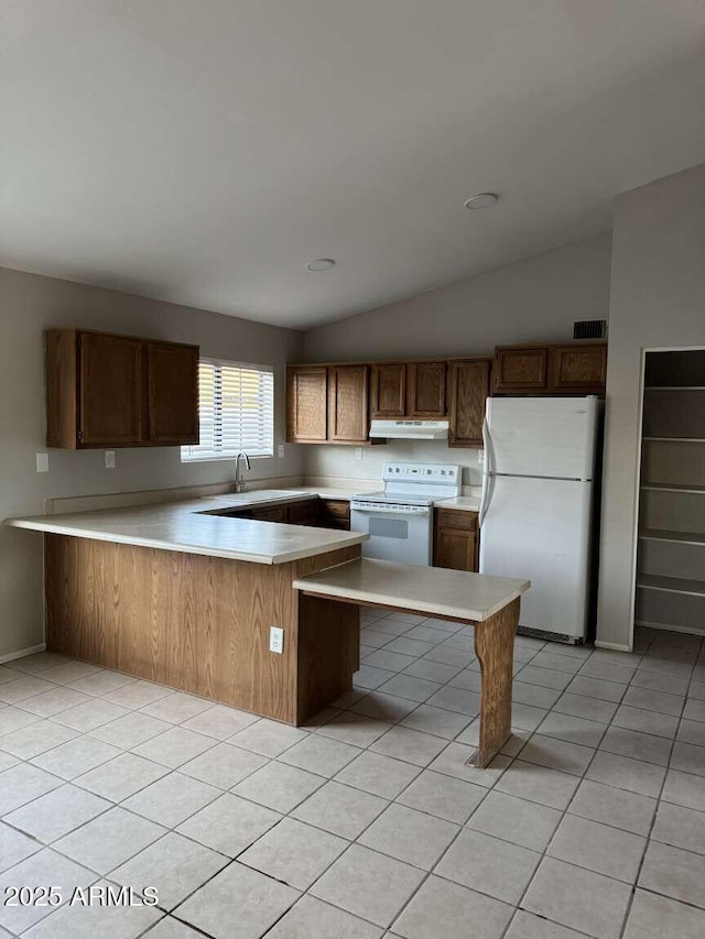 kitchen with light tile patterned flooring, white appliances, lofted ceiling, and kitchen peninsula