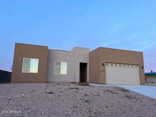 southwest-style home with a garage