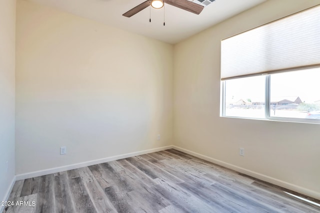 empty room with light hardwood / wood-style floors and ceiling fan