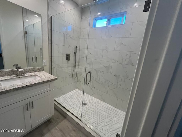 bathroom featuring an enclosed shower and vanity