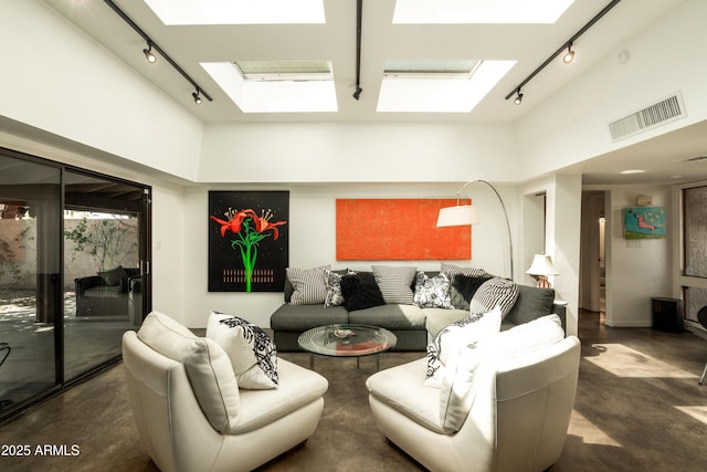 4525 N 66th St Unit 112, Scottsdale, AZ 85251 - living area featuring rail lighting, a skylight, a towering ceiling, and concrete flooring