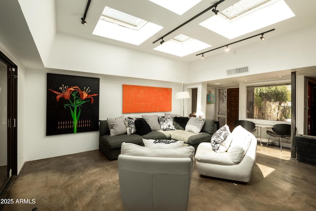 4525 N 66th St Unit 112, Scottsdale, AZ 85251 - living room with rail lighting, a skylight, a high ceiling, and concrete floors