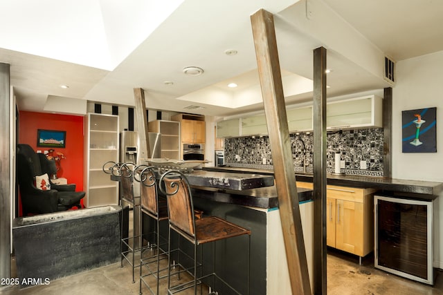 4525 N 66th St Unit 112, Scottsdale, AZ 85251 - kitchen with wine cooler, concrete flooring, stainless steel oven, light brown cabinetry, and recessed lighting