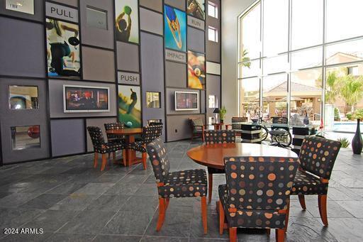 dining area featuring a high ceiling, a healthy amount of sunlight, and expansive windows