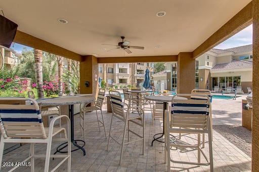 view of patio with outdoor dry bar and ceiling fan