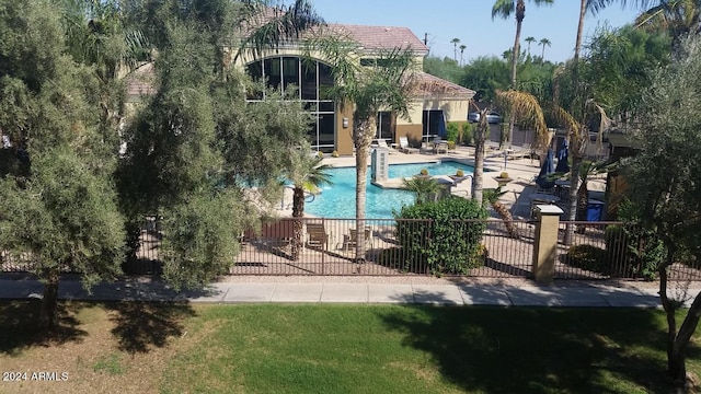 community pool with a patio area, a yard, and fence private yard