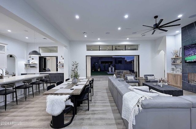 living room featuring light hardwood / wood-style flooring and ceiling fan