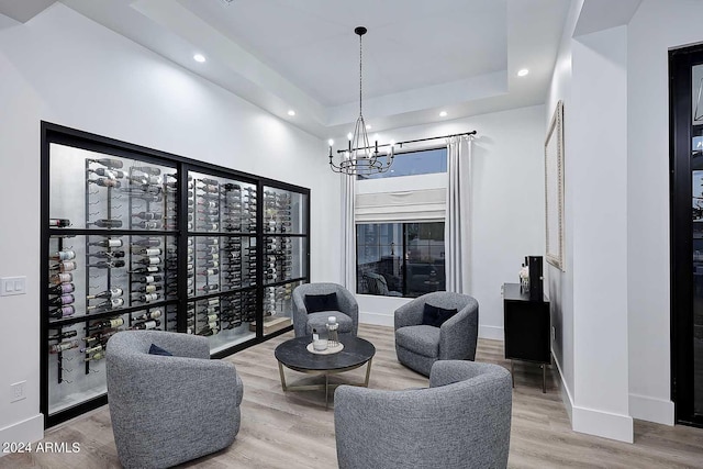 living room with an inviting chandelier and hardwood / wood-style floors