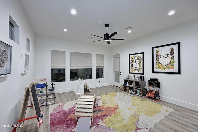 interior space with wood-type flooring and ceiling fan