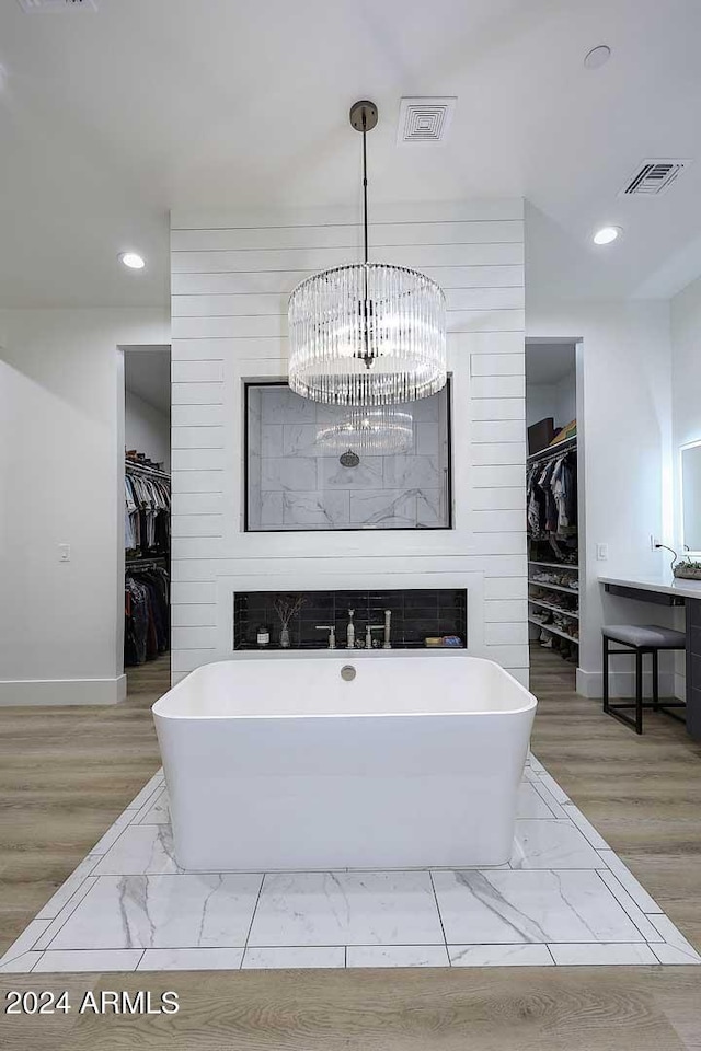 bathroom with a bath and hardwood / wood-style flooring