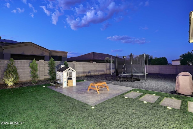 view of yard featuring a patio and a trampoline