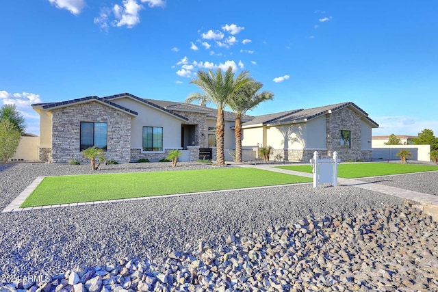 ranch-style home featuring a front lawn