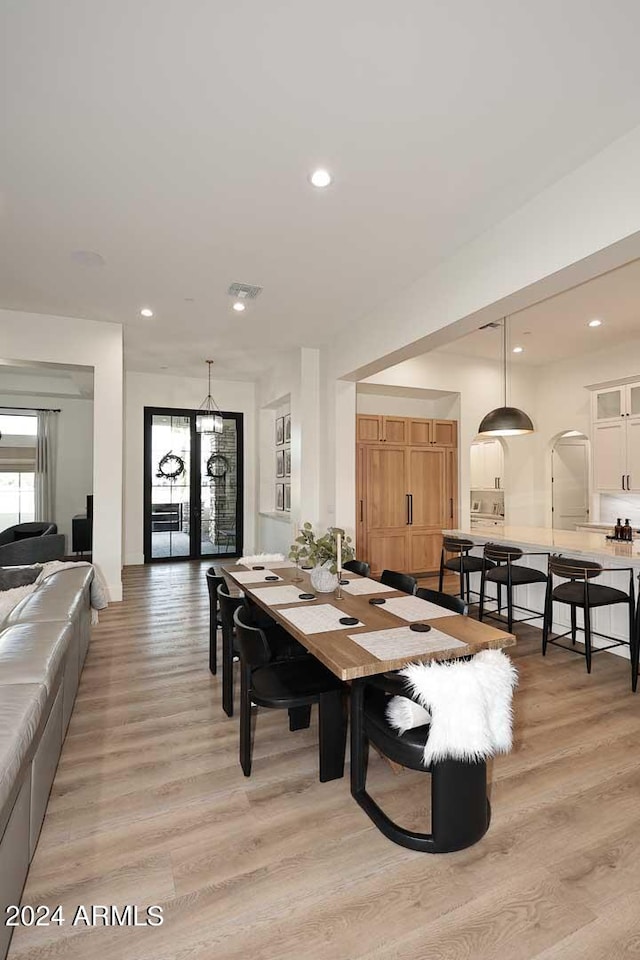 dining space with light hardwood / wood-style floors