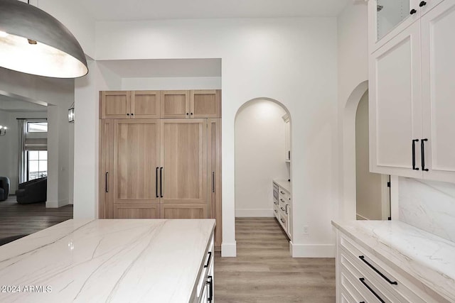 bedroom with light hardwood / wood-style floors and a closet