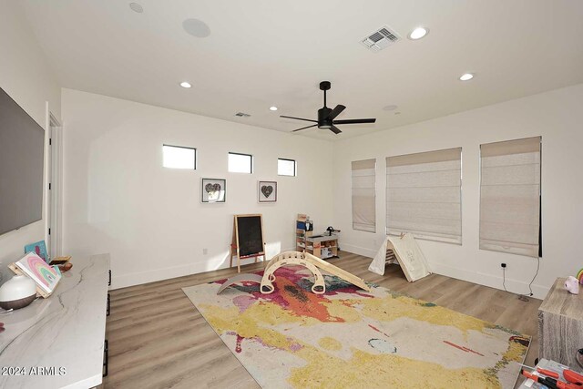 recreation room featuring wood-type flooring and ceiling fan