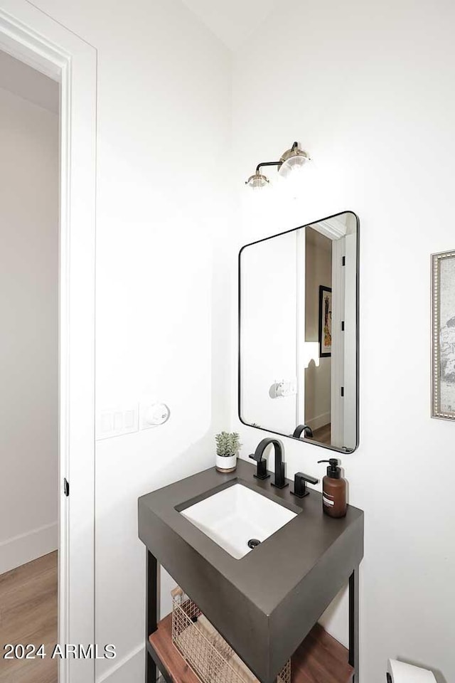 bathroom with hardwood / wood-style floors and sink