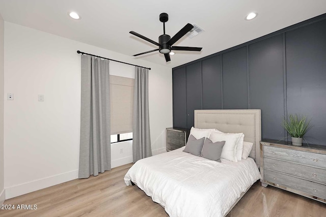 bedroom with light hardwood / wood-style floors and ceiling fan