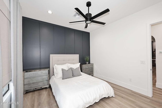 bedroom with ceiling fan and light wood-type flooring