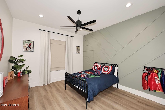 bedroom with light hardwood / wood-style flooring and ceiling fan