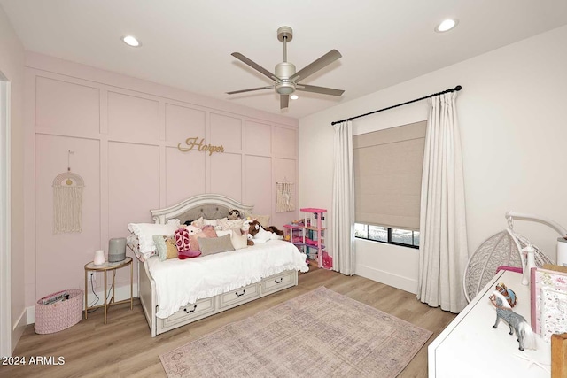 bedroom with ceiling fan and light hardwood / wood-style flooring