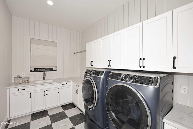 laundry room with cabinets, sink, and washing machine and dryer