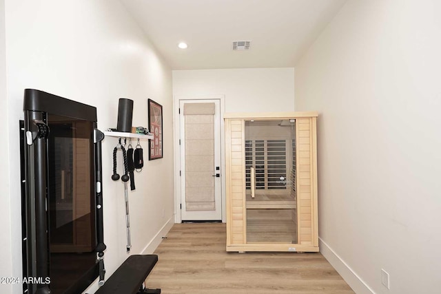 corridor with light hardwood / wood-style floors